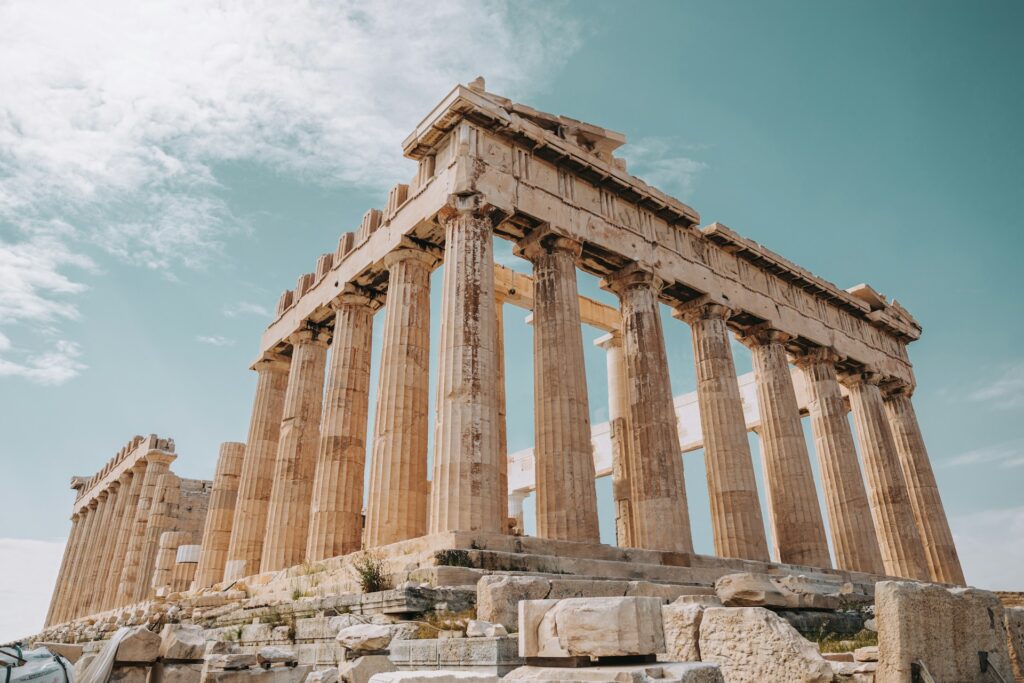 The Parthenon's corner, standing tall against a bright blue sky
