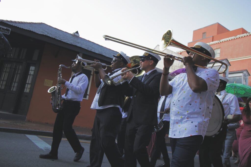 A marching band parading through New Orleans, playing brass instruments