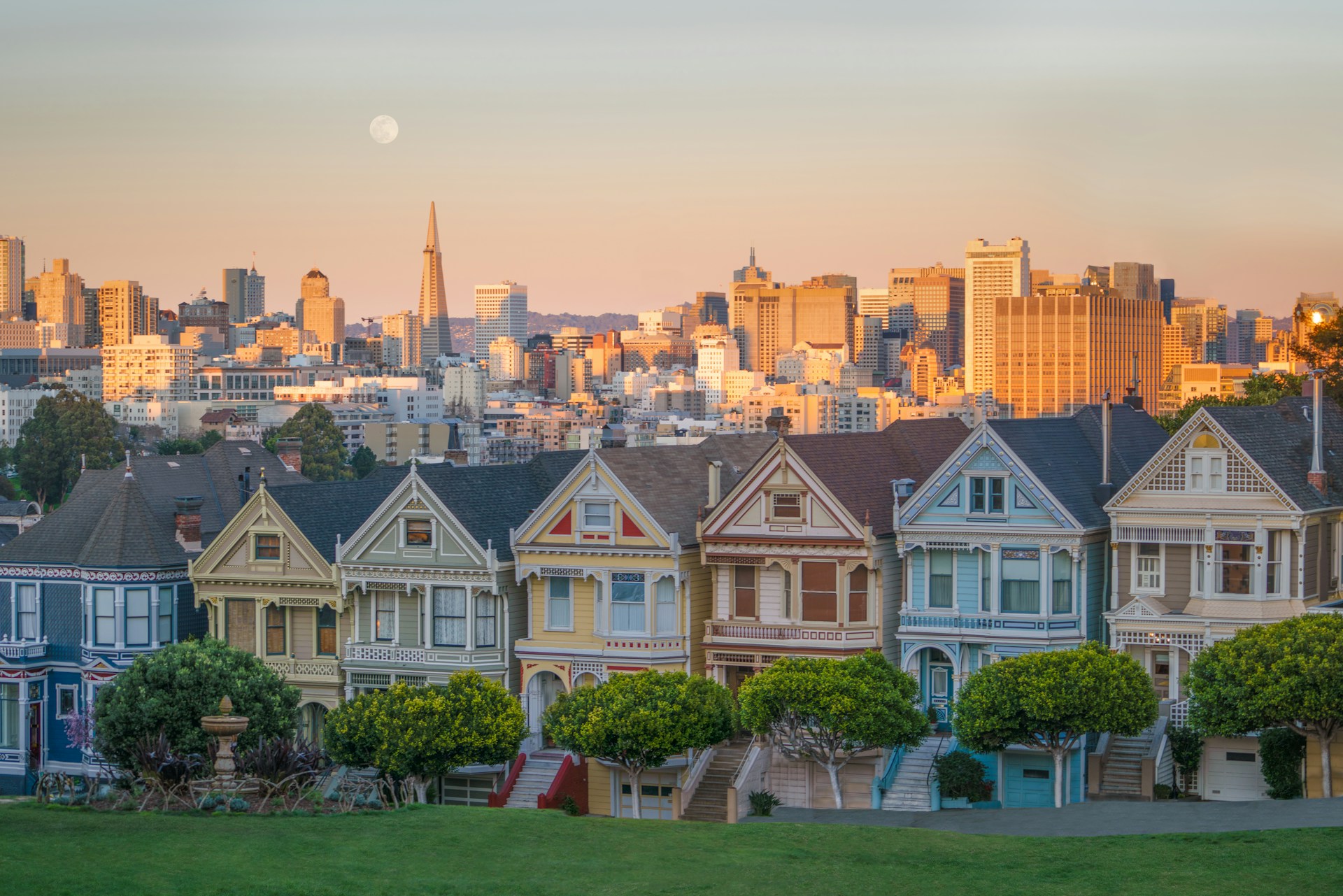 A setting moon above the famous Painted Ladies - San Francisco