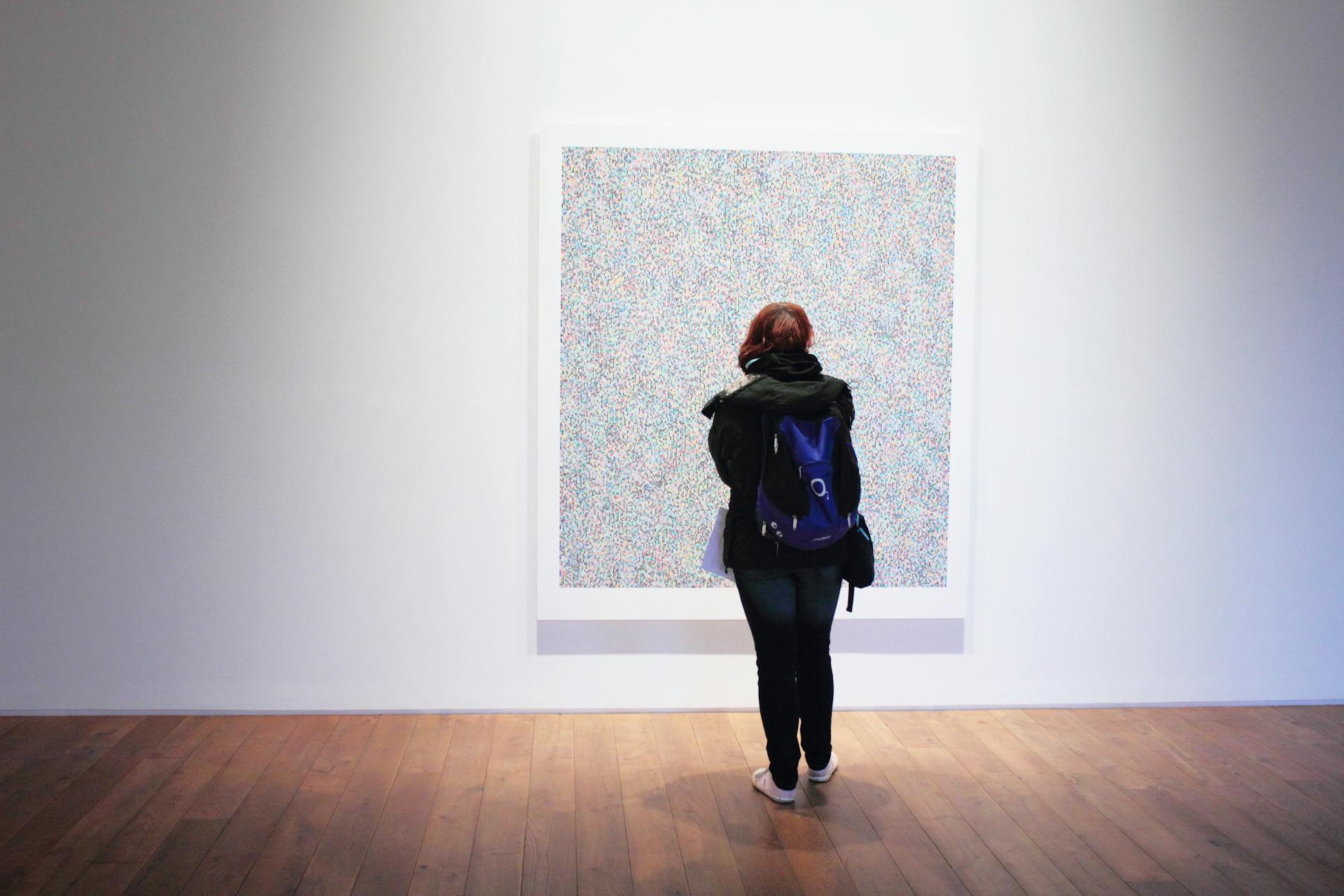 Woman standing in front of a painting