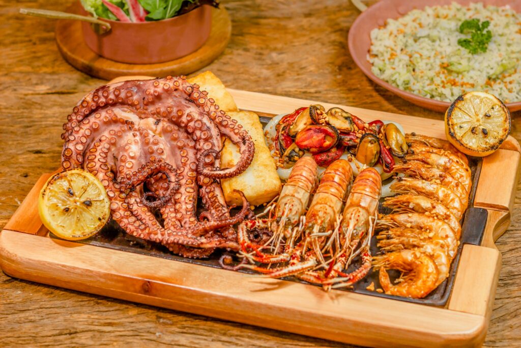 A plate of seafood, with octopus and shrimp